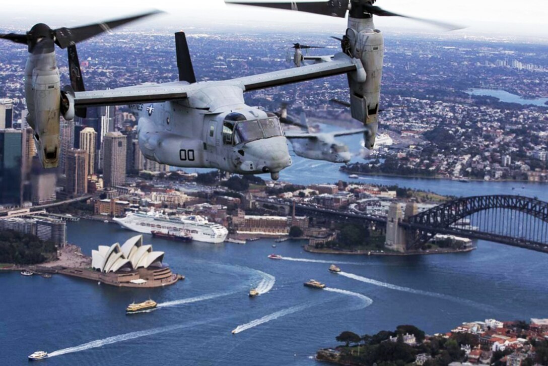 An MV-22B Osprey tiltrotor aircraft flies above Sydney Harbor in Australia, June 29, 2017. Below are the world famous Sydney Opera House and Sydney Harbor Bridge. Marine Corps photo by Staff Sgt. T. T. Parish