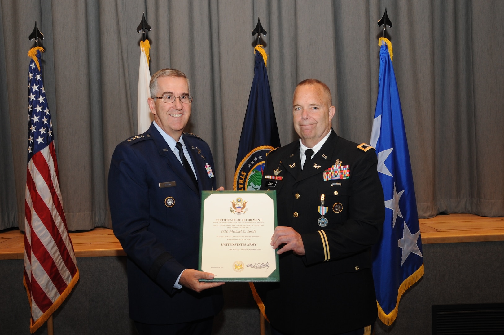 U.S. Army Col. Michael Smidt, U.S. Strategic Command (USSTRATCOM) staff judge advocate, accepts his certificate of retirement from U.S. Air Force Gen. John E. Hyten, commander of USSTRATCOM, during a ceremony at Offutt Air Force Base, Neb., July 7, 2017. Smidt retired from the U.S. Army after 41 years of service. Smidt began his career as an airborne infantryman before serving 10 years in the U.S. Army Reserve as a Green Beret. In addition, he completed various assignments in operational law and military justice; he also served as the staff judge advocate for the 1st Infantry Division and as a professor of international and operational law at the U.S. Army Judge Advocate General’s School prior to his assignment to USSTRATCOM. 