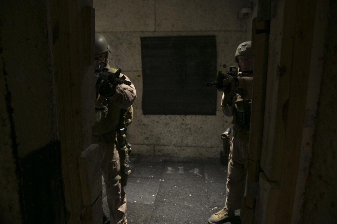 Close Quarters Battle instructors with Training Co., Marine Corps Security Force Regiment, conduct doorway assessments before entering an area to be cleared during Instructor Progression Training aboard Naval Support Activity Northwest Annex, Chesapeake, Va., June 23. CQB and Interior Tactics instructors were required to attend this quarterly training to ensure they stay qualified, and retain the knowledge they teach during their courses. (U.S. Marine Corps photo by Sgt. Kayla D. Rivera/Released)