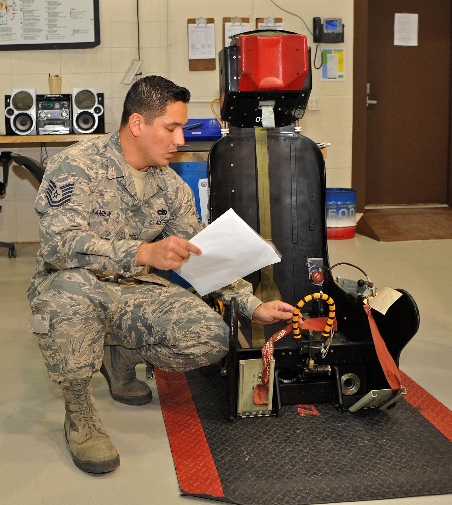 Tech. Sgt. Jonathan Sandlin, 9th Maintenance Squadron assistant section chief, reviews a checklist while inspecting a U-2 Dragon Lady ejection seat Jan. 23, 2017 at Beale Air Force Base, Calif. The ejection seat allows a pilot to quickly escape an aircraft in the event of an emergency. (U.S. Air Force photo/Airman 1st Class Tristan D. Viglianco)