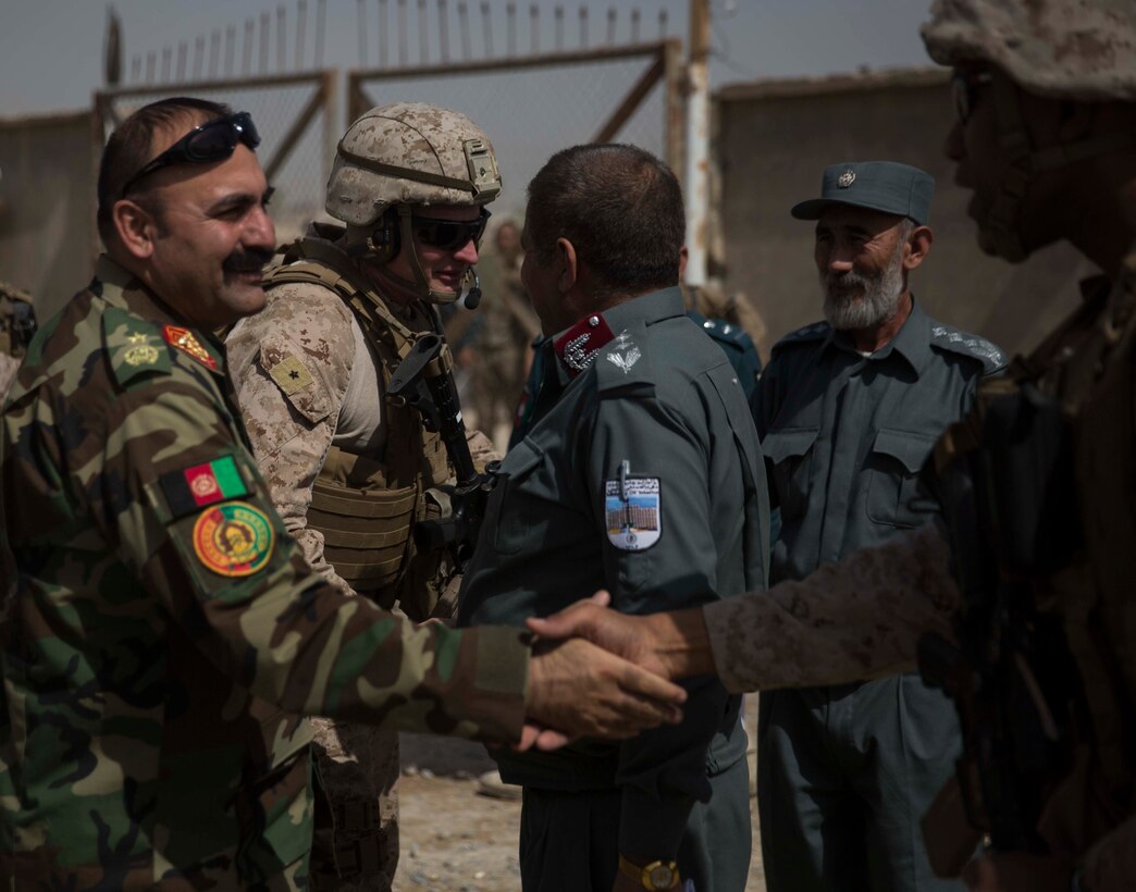 Brig. Gen Roger Turner, second from left, the commanding general of Task Force Southwest, and Col. David Gibbs, right, the commanding officer for team police, Task Force Southwest, greet their Afghan National Defense and Security Force partners after arriving at the Helmand Provincial Police Headquarters in Lashkar Gah, Afghanistan, July 9, 2017. This mission provided an opportunity for advisors to meet with their counterparts, review the security posture at the PHQ and ensure that Afghan National Defense and Security Forces have an effective defense of Lashkar Gah. (U.S. Marine Corps photo by Sgt. Justin T. Updegraff)