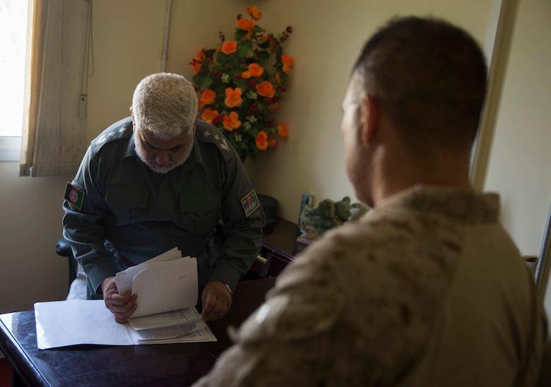 U.S. Marine advisors with Task Force Southwest speak with their counterpart during a train, advise and assist mission at the Helmand Provincial Police Headquarters in Lashkar Gah, Afghanistan, July 9, 2017. This mission provided an opportunity for advisors to meet with their counterparts, review the security posture at the PHQ and ensure that Afghan National Defense and Security Forces have an effective defense of Lashkar Gah. (U.S. Marine Corps photo by Sgt. Justin T. Updegraff)