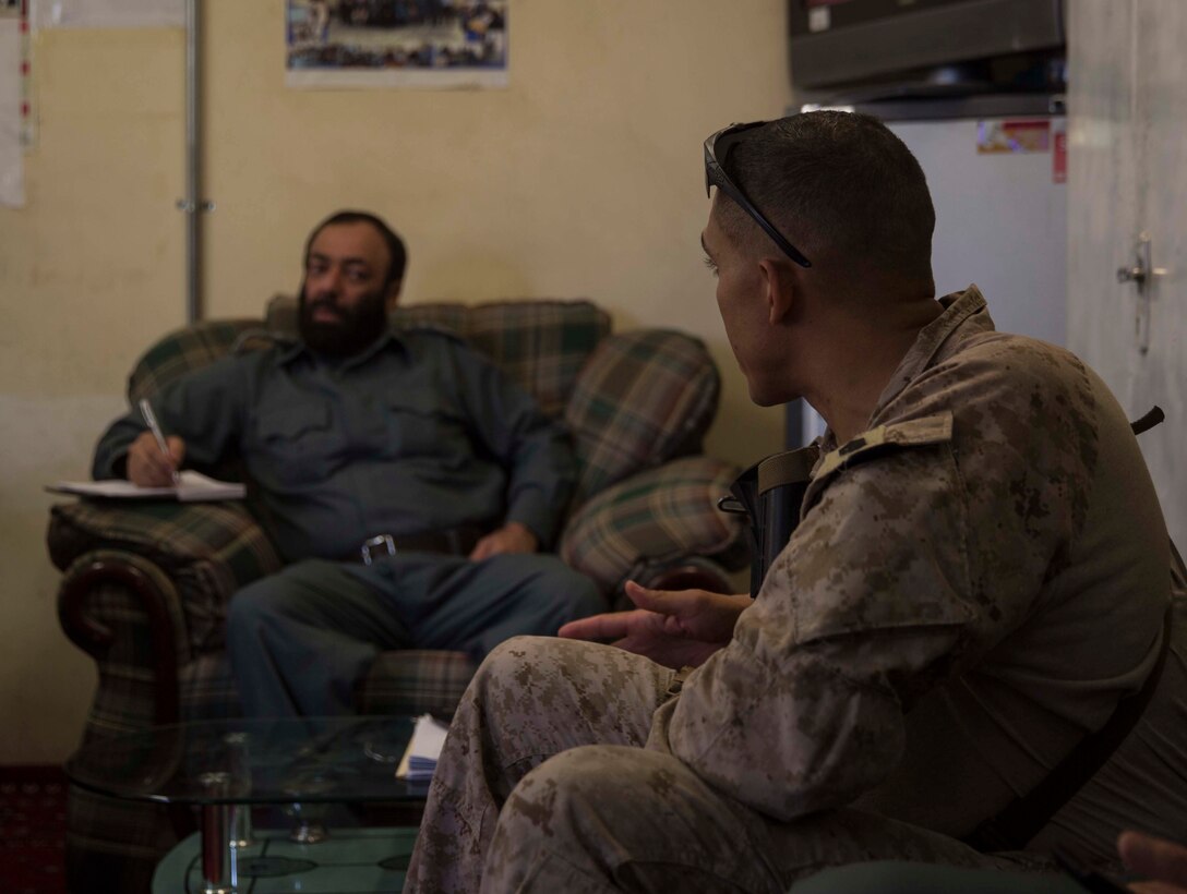 A U.S. Marine advisor with Task Force Southwest speaks with his counterpart during a train, advise and assist mission at the Helmand Provincial Police Headquarters in Lashkar Gah, Afghanistan, July 9, 2017. This mission provided an opportunity for advisors to meet with their counterparts, review the security posture at the PHQ and ensure that Afghan National Defense and Security Forces have an effective defense of Lashkar Gah. (U.S. Marine Corps photo by Sgt. Justin T. Updegraff)