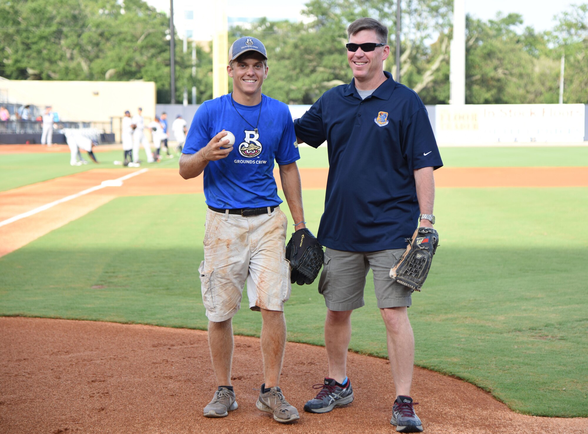 Col. C. Mike Smith, 81st Training Wing vice commander, poses for a photo with his son, Mac, during the Biloxi Shuckers Minor League Baseball team’s military appreciation night July 8, 2017, in Biloxi, Miss. The Shuckers recognized and honored service members and their families for the dedication, commitment and sacrifices they make for the nation. (U.S. Air Force photo by Kemberly Groue)