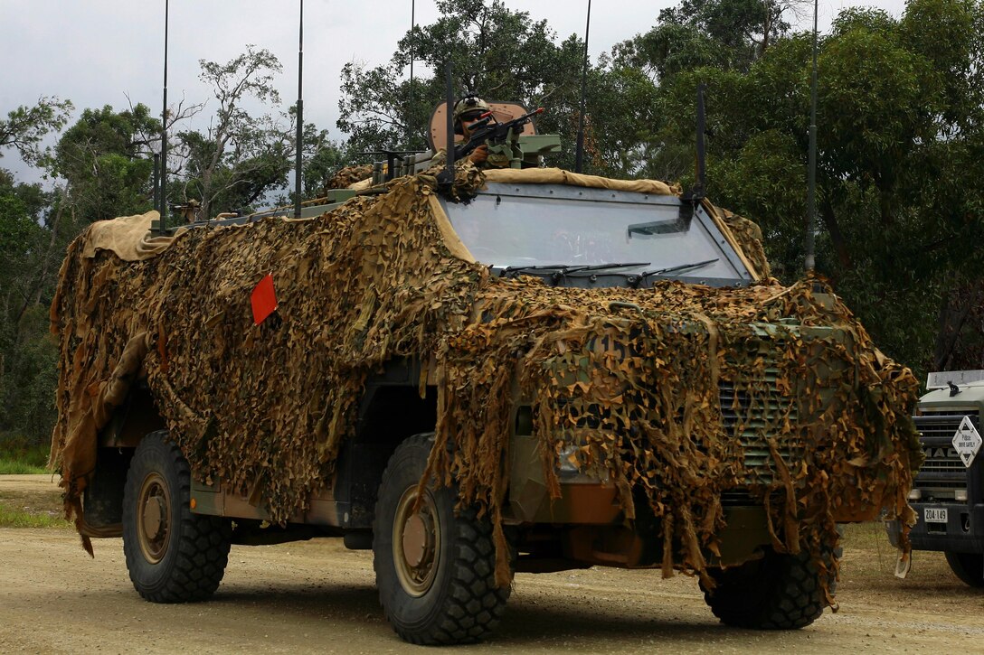 An Australian soldier mans a machine gun atop a protected mobility vehicle during exercise Talisman Saber at the Shoalwater, training area in Queensland, Australia, July 10, 2017. Army National Guard photo by Sgt. Alexander Rector