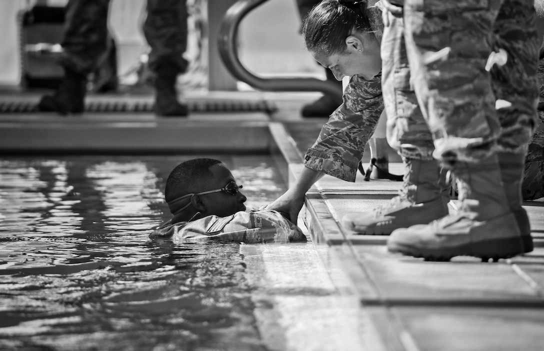 An Airman is comforted after disqualifying on the 100 meter swim portion of the German Armed Forces Badge for Military Proficiency test at Joint Base McGuire-Dix-Lakehurst, N.J., June 13, 2017. (U.S. Air National Guard photo by Master Sgt. Matt Hecht/Released)