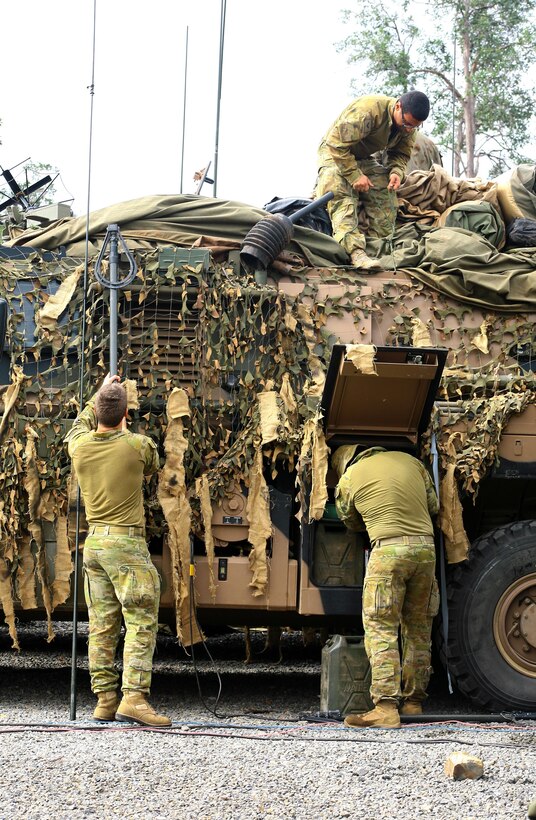 U.S. and Australian soldiers attach equipment to an Australian protected mobility vehicle while preparing for exercise Talisman Saber at the Shoalwater Bay training area in Queensland, Australia, July 10, 2017. Army National Guard photo by Sgt. Alexander Rector