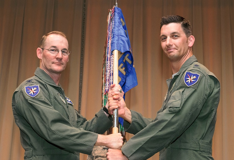 Lt. Col. Peter Hansen, right, accepts the 5th Flying Training Squadron’s guidon from Col. Roger Suro, 340th Flying Training Group commander, during a change-of-command ceremony held July 7 in the Base Auditorium at Vance Air Force Base, Oklahoma. (U.S. Air Force photo/ Terry Wasson)
