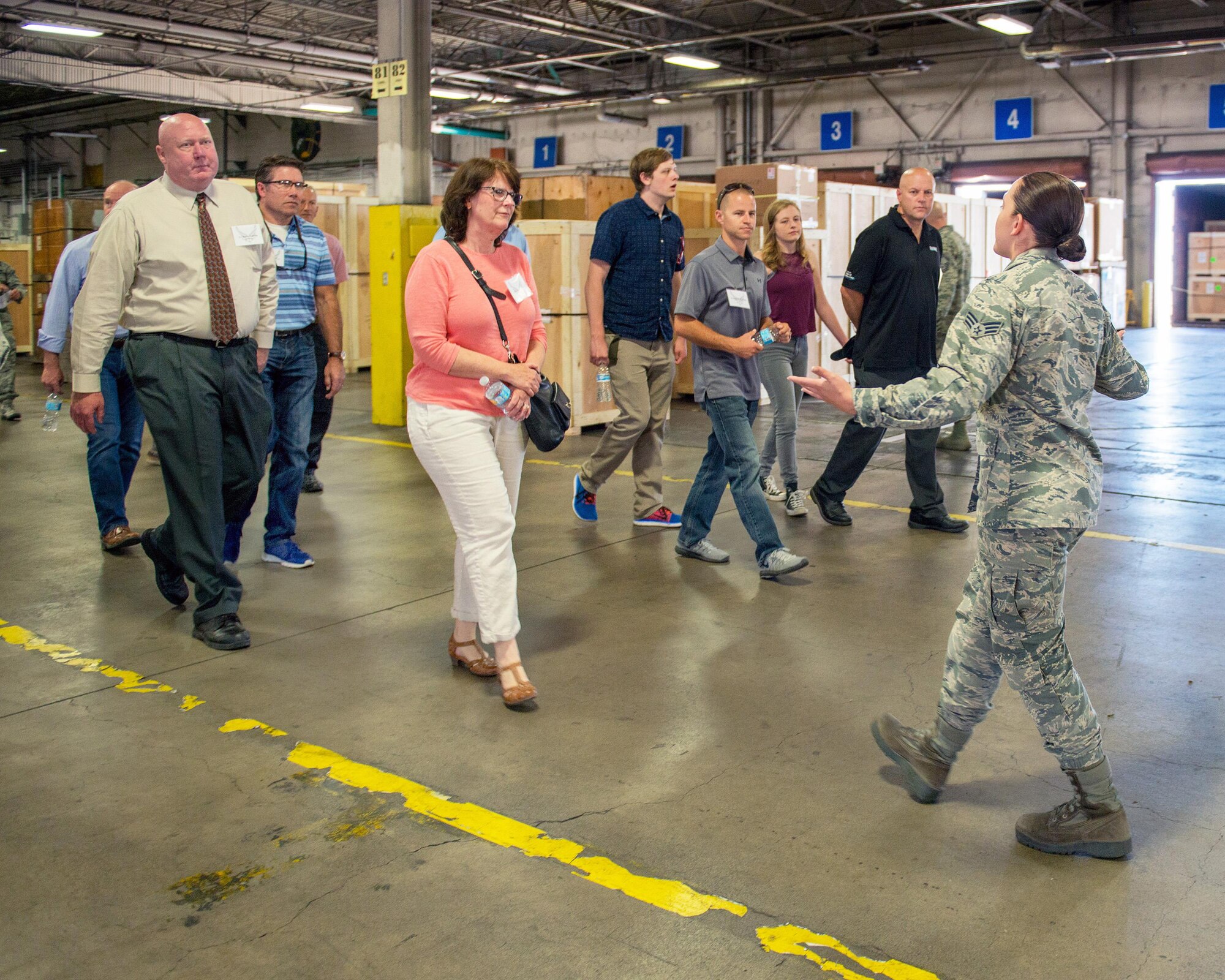 U.S. Air Force Senior Airman Elizabeth Green, 60th Aerial Port Squadron, gives honorary commanders from Travis Air Force Base, Calif., a briefing during their tour at the base, July 7, 2017. The purpose of the Honorary Commander Program is to promote relationships between base senior leadership and civilian partners, foster civic appreciation of the Air Force mission and its Airmen, maximize opportunities to share the Air Force story with new stewards, and to communicate the mutual interests, challenges, and concerns that senior leaders and civilian stakeholders have in common. (U.S. Air Force photo by Louis Briscese)