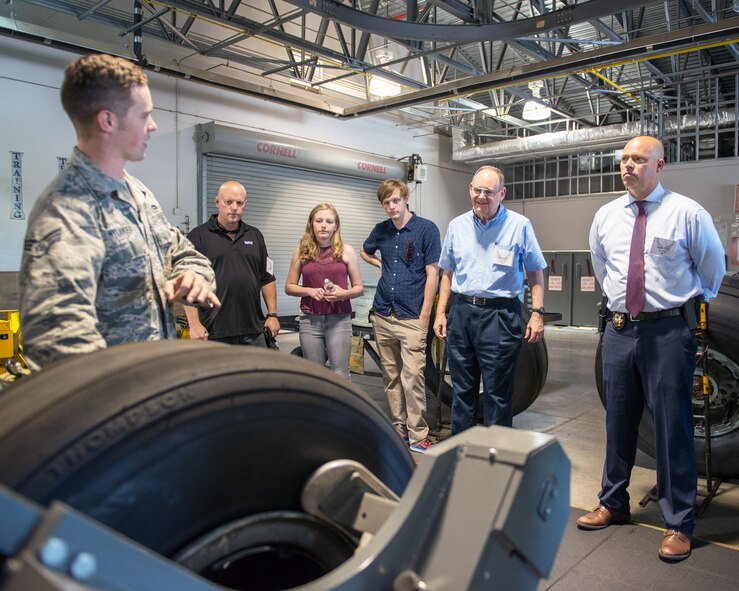 U.S. Air Force Senior Airman Kelby Nylander, 60th Maintenance Squadron, gives honorary commanders from Travis Air Force Base, Calif., a briefing during their tour at the base, July 7, 2017. The purpose of the Honorary Commander Program is to promote relationships between base senior leadership and civilian partners, foster civic appreciation of the Air Force mission and its Airmen, maximize opportunities to share the Air Force story with new stewards, and to communicate the mutual interests, challenges, and concerns that senior leaders and civilian stakeholders have in common. (U.S. Air Force photo by Louis Briscese