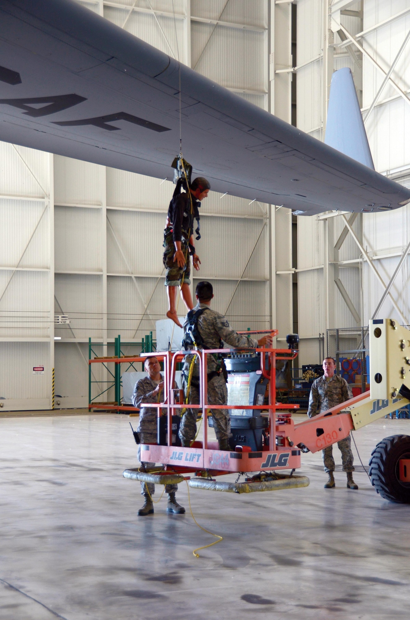 445th Aircraft Maintenance Squadron crew chief Staff Sgt. Michael Wilson operates a boom lift underneath the wing of a C-17 Globemaster III while participating in fall protection training here alongside fellow crew chiefs Tech. Sgt. Chris Knight and Senior Airman Cody Gaure during the June 3, 2017 unit training assembly. The training ensures that maintainers take proper and timely steps to rescue an Airmen if they were to fall from an aircraft. (U.S. Air Force photo/Staff Sgt. Joel McCullough)