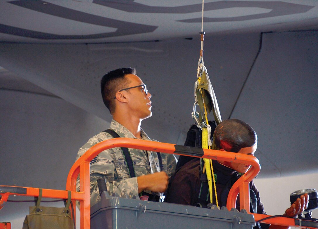 Staff Sgt. Michael Wilson, a 445th Aircraft Maintenance Squadron crew chief, unhooks a training manikin’s harness during fall protection training here, June 3, 2017. Wilson uses a boom lift to retrieve the “Airman” and lower him to safety. The training ensures that maintainers take proper and timely steps to rescue an Airmen if they were to fall from an aircraft. (U.S. Air Force photo/Staff Sgt. Joel McCullough)