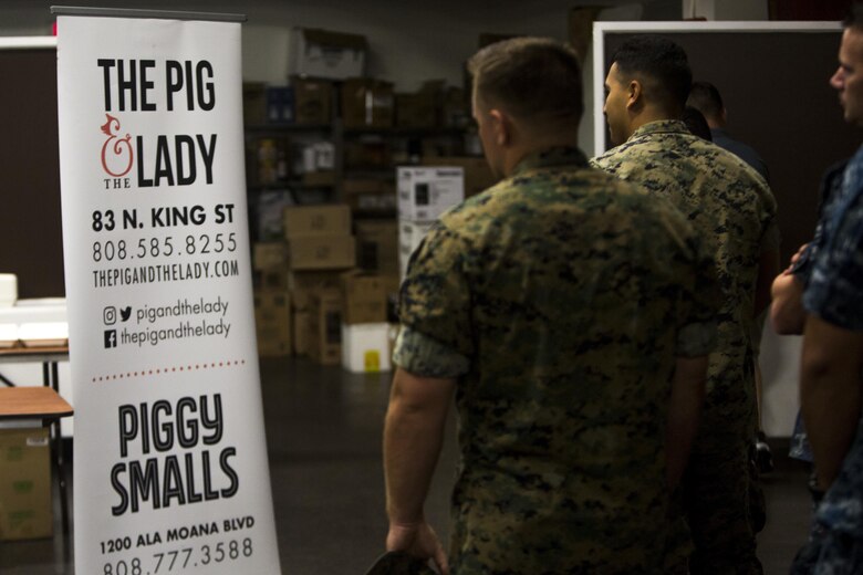 Marines and Sailors aboard Marine Corps Base Hawaii enter the Kahuna’s Sports Bar and Grill ballroom on base to receive a free lunch provided by “The Pig and The Lady” restaurant, July 7, 2017. The Pig and The Lady hosted a free lunch last year due to a customer offering to pay for all military members. “I thought of John Nishida, [The Director of Business Operations for Food and Hospitality with Marine Corps Community Services] a good friend of mine,” said Alex Le, a chef with The Pig and The Lady. “We coordinated and the donor put up the money to fund the free lunch.” (U.S. Marine Corps photo by Lance Cpl. Isabelo Tabanguil)