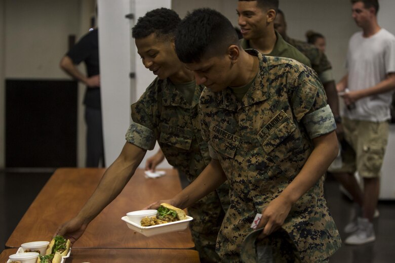 A Marine grabs a meal during a free lunch hosted by “The Pig and The Lady” restaurant at the Kahuna’s Sports Bar and Grill ballroom, July 7, 2017. The Pig and The Lady hosted a free lunch last year due to a customer offering to pay for all military members. “I thought of John Nishida, [The Director of Business Operations for Food and Hospitality with Marine Corps Community Services] a good friend of mine,” said Alex Le, a chef with The Pig and The Lady. “We coordinated and the donor put up the money to fund the free lunch.” (U.S. Marine Corps photo by Lance Cpl. Isabelo Tabanguil)