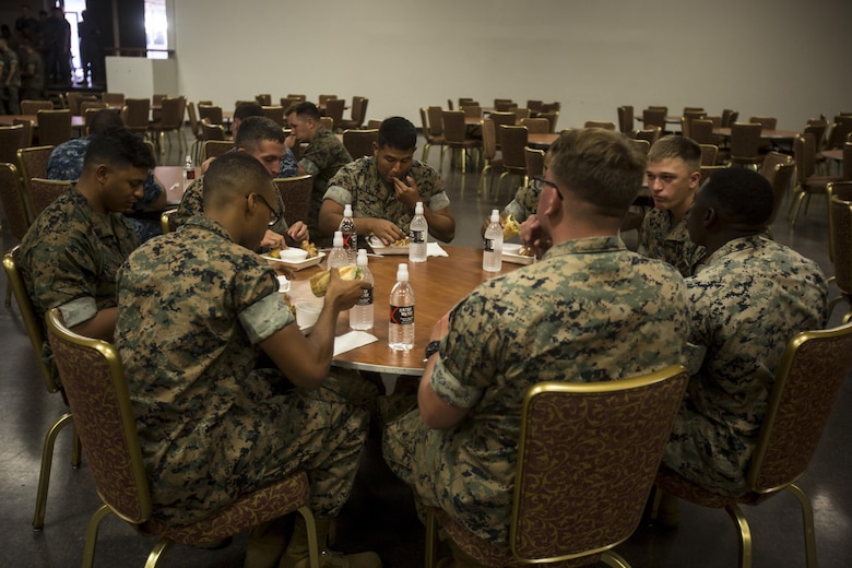 Marines aboard Marine Corps Base Hawaii eat a free meal at Kahuna’s Sports Bar and Grill, which was provided by “The Pig and The Lady” restaurant, July 7, 2017. The Pig and The Lady hosted a free lunch last year due to a customer offering to pay for all military members. “I thought of John Nishida, [The Director of Business Operations for Food and Hospitality with Marine Corps Community Services] a good friend of mine,” said Alex Le, a chef with The Pig and The Lady. “We coordinated and the donor put up the money to fund the free lunch.” (U.S. Marine Corps photo by Lance Cpl. Isabelo Tabanguil)