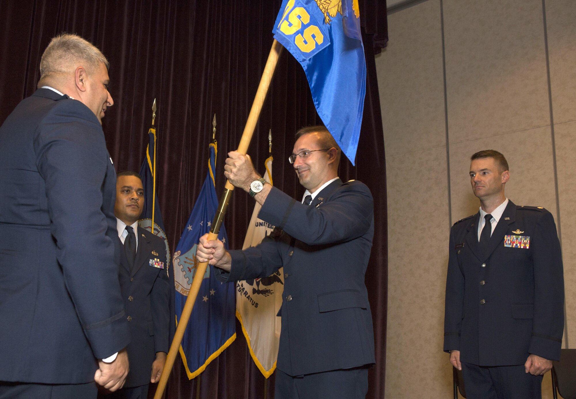 Lt. Col. Scott Nichols, middle, 920th Operations Support Squadron commander, takes the unit guidon from Col. Michael LoForti, 920th Operations Group commander, during the squadron change of command ceremony July 9, 2017 at Patrick Air Force Base, Florida. (U.S. Air Force photo/Master Sgt. Mark Borosch)