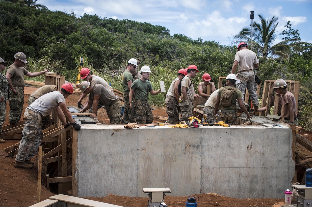 Ohio Air National Guard members, assigned to the 200th Rapid Engineer Deployable Heavy Operational Repair Squadron Engineers, work with Marines, assigned to the Engineer Services Company, Springfield, Ore., and Navy Seabees, assigned to the Naval Mobile Construction Battalion 25, Port Hueneme, Calif., to conduct Innovative Readiness Training in Kapaa, Hawaii, July 10, 2017. IRT is a military volunteer training opportunity that provides training and readiness while addressing public and civil-society needs. Air National Guard photo by 1st Lt. Paul Stennett