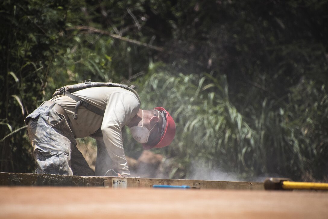 Ohio Air National Guard Tech. Sgt. Alex Sorgenfrei, assigned to the 200th Rapid Engineer Deployable Heavy Operational Repair Squadron Engineers, prepares concrete during Innovative Readiness Training in Kapaa, Hawaii, July 10, 2017. Air National Guard photo by 1st Lt. Paul Stennett