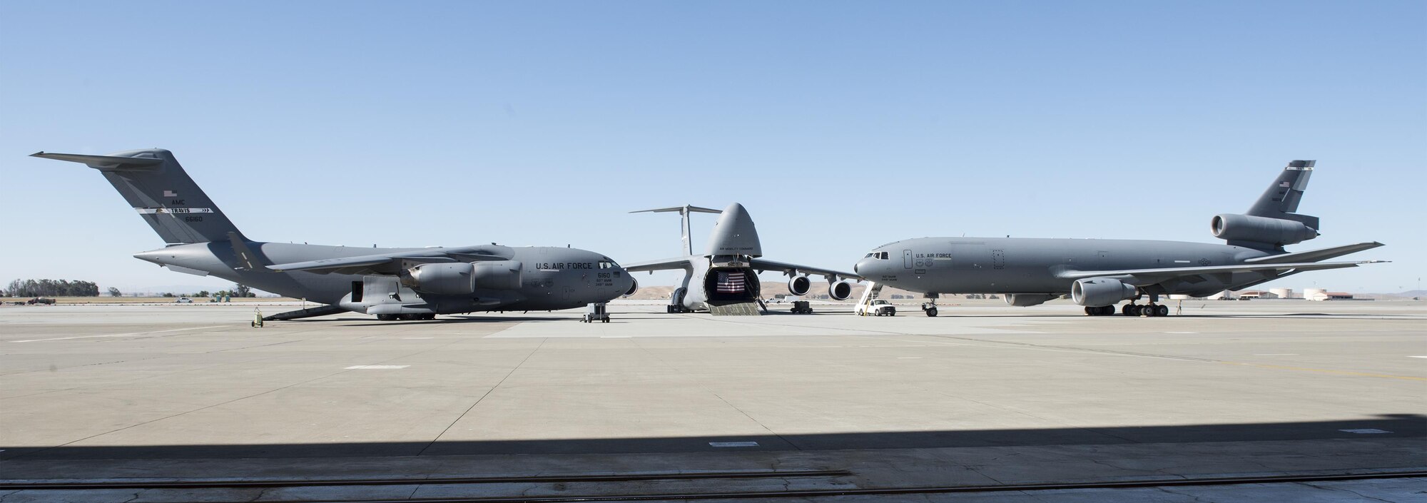Aircraft assigned to the 60th Air Mobility Wing sit as static displays during the 60th Operations Group Change of Command ceremony at Travis Air Force Base, Calif., Jul 7, 2017. During the ceremony, Col. Christopher V. Maddox relinquished command to Col. Theresa E. Weems. The 60th OG is responsible for daily air operations of the largest air mobility wing in the U.S. Air Force. (U.S. Air Force photo by Heide Couch)