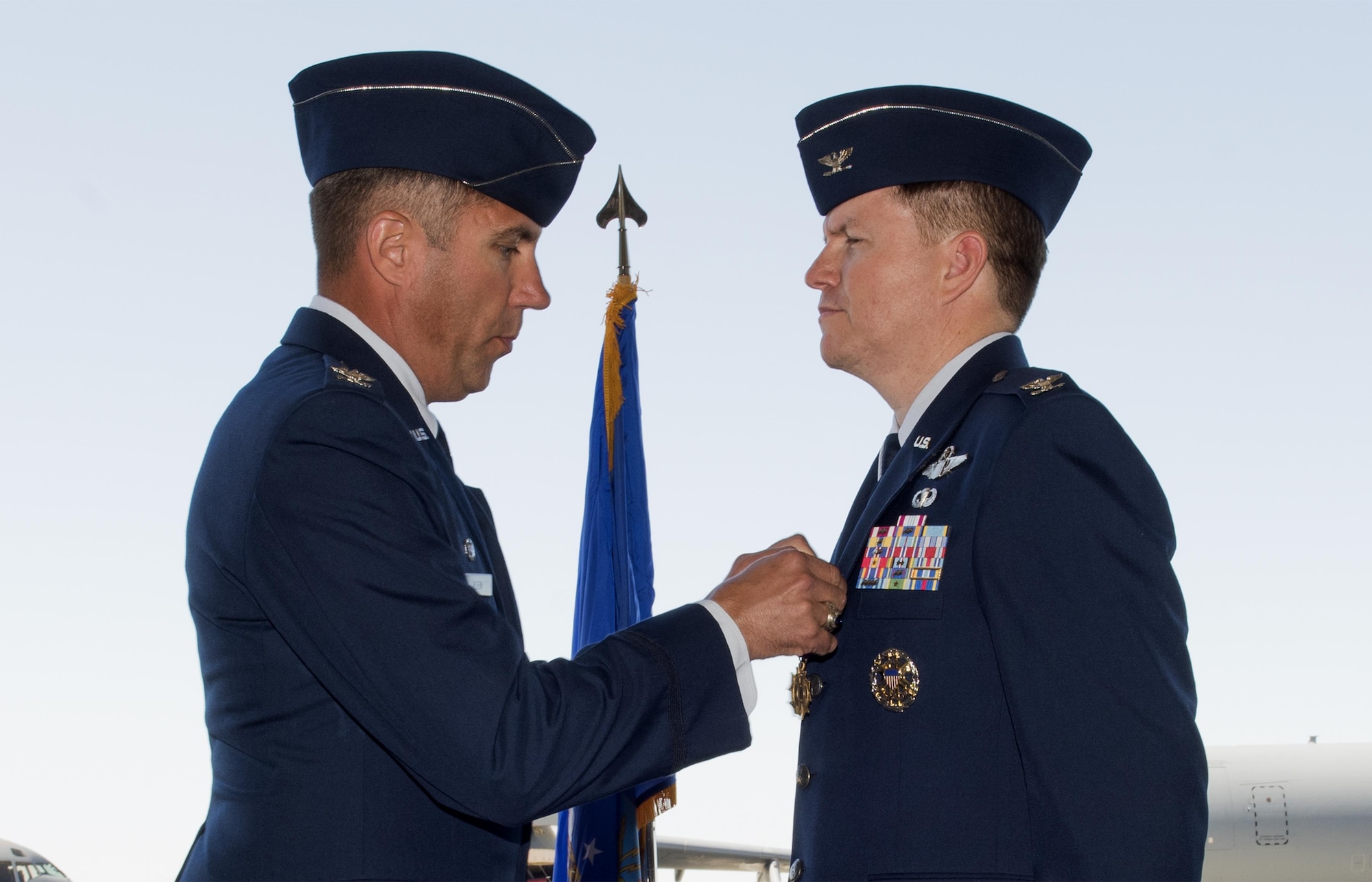U.S. Air Force Col. John Klein, 60th Air Mobility Wing commander, pins a decoration on Col. Christopher V. Maddox, 60th Operations Group commander, during the 60th OG Change of Command ceremony at Travis Air Force Base, Calif., Jul 7, 2017. The 60th OG is responsible for daily air operations for the largest air mobility wing in the U.S. Air Force. (U.S. Air Force photo by Heide Couch)