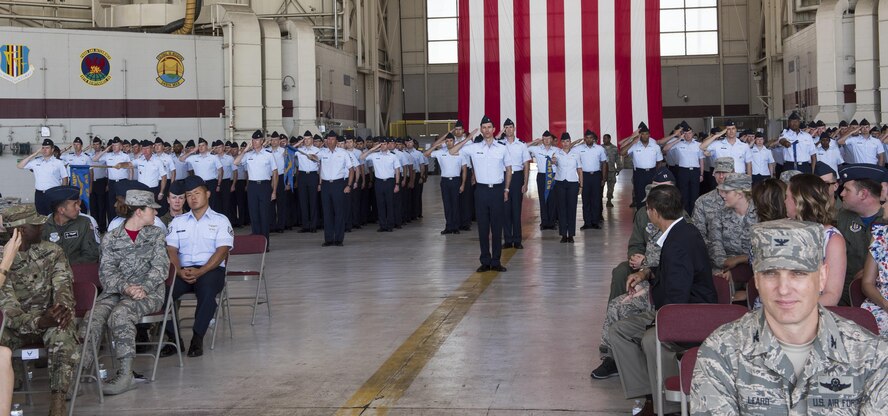Airmen assigned to the 60th Operations Group stand in formation during the 60th OG Change of Command ceremony at Travis Air Force Base, Calif., Jul 7, 2017. During the ceremony, Col. Christopher V. Maddox relinquished command to Col. Theresa E. Weems. The ceremony is rooted in military history dating back to the 18th Century where the command flag is passed to the individual assuming command in the presence of the entire unit. (U.S. Air Force photo by Heide Couch)