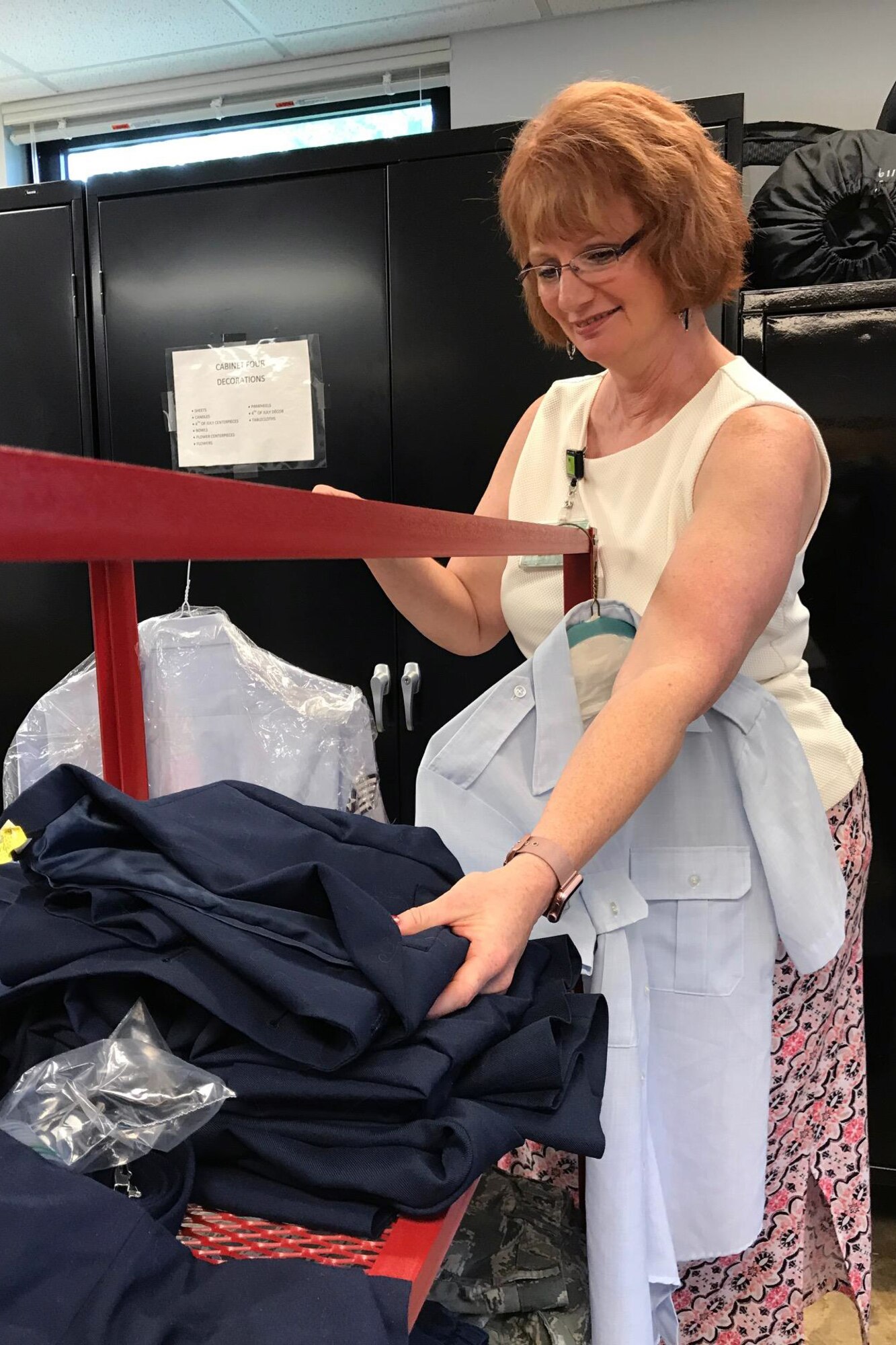 Jill Marconi-Pyclik, 434th Force Support Squadron Airman and Family Readiness director, folds Air Force blues uniforms at the Airman's Attic at Grissom Air Reserve Base, Ind., July 8, 2017. Marconi-Pyclik spearheaded the first Grissom's Airman's Attic, slated to open during the September unit training assembly. (U.S. Air Force photo/Staff Sgt. Katrina Heikkinen)