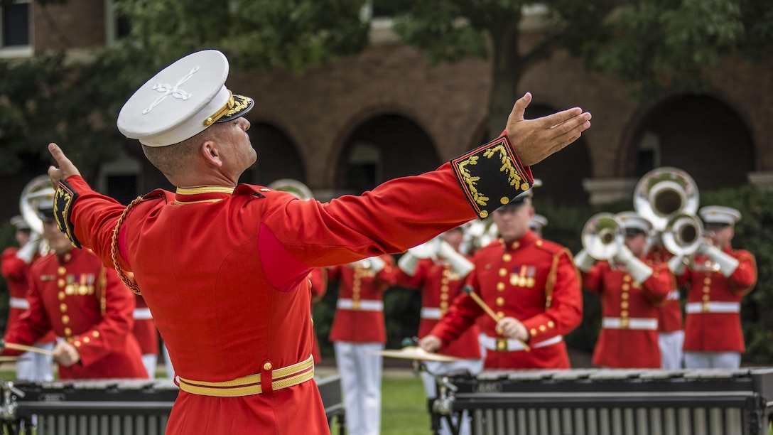 Marine Corps Maj. Christopher E. Hall, commanding officer of the U.S. Marine Drum and Bugle Corps, conducts a performance at Marine Barracks Washington, D.C., July 10, 2017. Marine Corps photo by Cpl. Samantha K. Braun