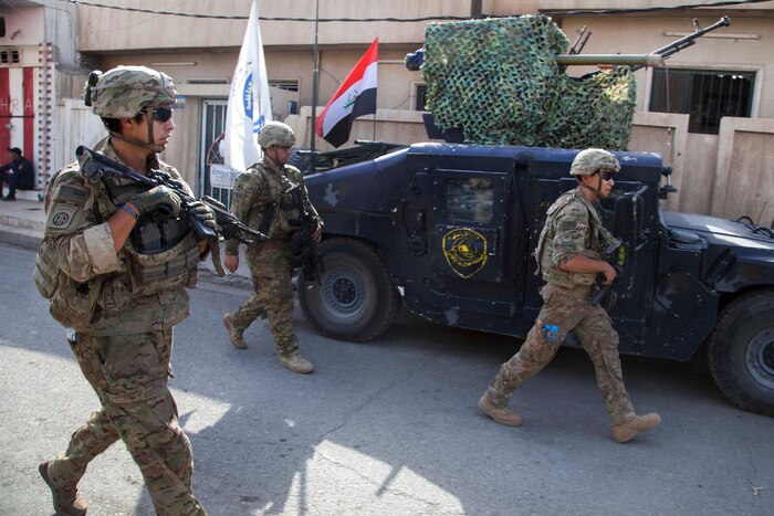 U.S. paratroopers walk outside of an Iraqi Federal Police patrol base in Mosul, Iraq, July 4, 2017. Army photo by Cpl. Rachel Diehm