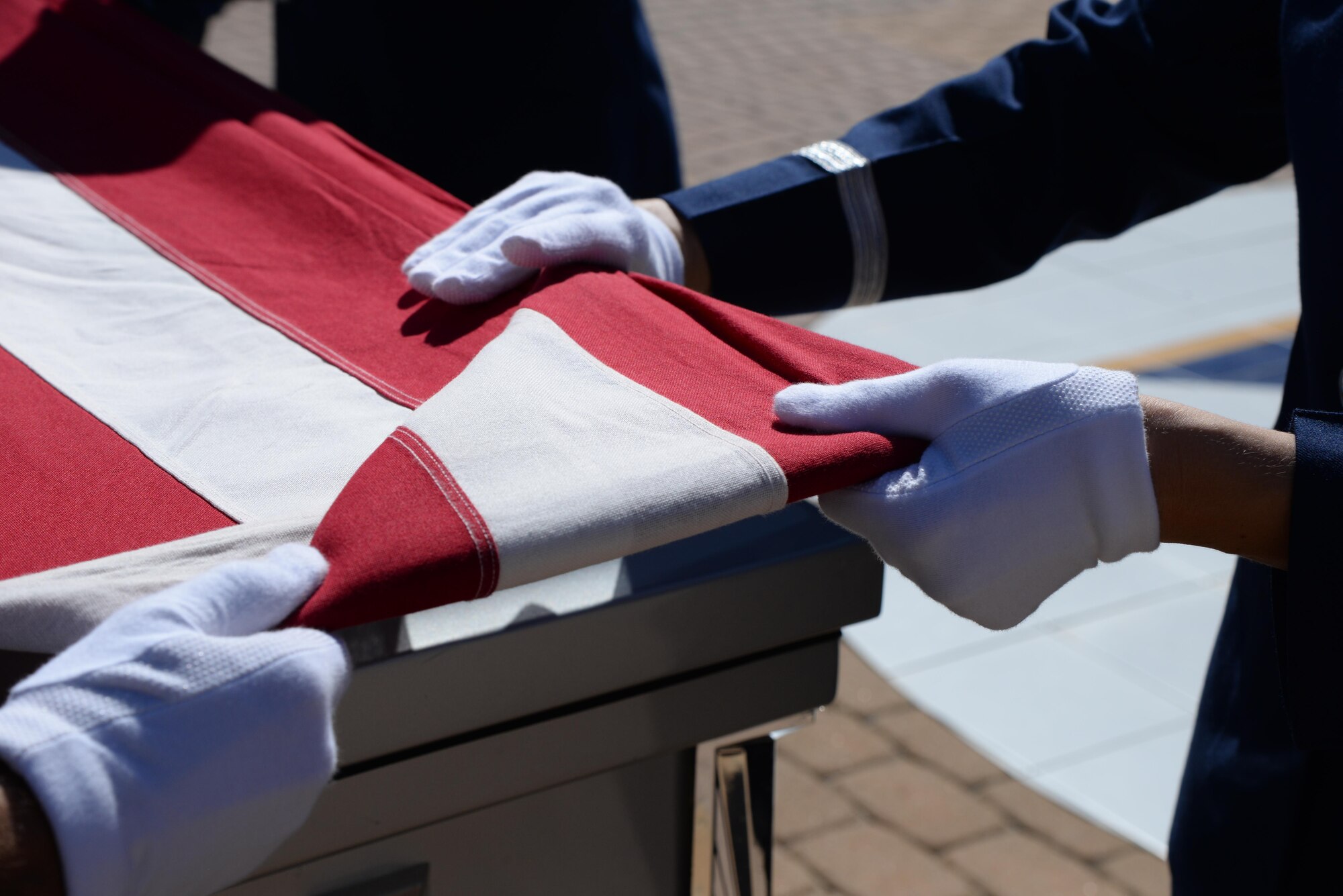 The flag of the United States is folded by members of Laughlin’s honor guard during a mock funeral at Laughlin Air Force Base, Tx., July 10, 2017.  According to Staff Sgt. Michael Bailey Jr., Honor Guard NCO in charge, Laughlin’s honor guard performed 109 details in 2016, and has already performed more than 50 drills in 2017. (U.S. Air Force/photo Airman 1st Class Daniel Hambor)