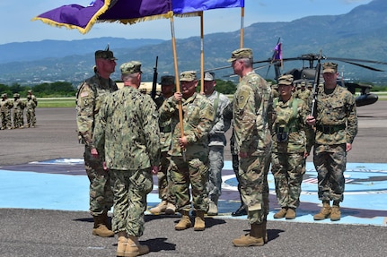 Col. Keith McKinley (left), Joint Task Force-bravo commander, Admiral Kurt Tidd (center) commander of U.S. Southern Command and Col. Brian Hughes (right), former commander of JTF-Bravo stand for the passing of the colors at Soto Cano Air Base, Honduras during the Change of Command ceremony July 10th, 2017.