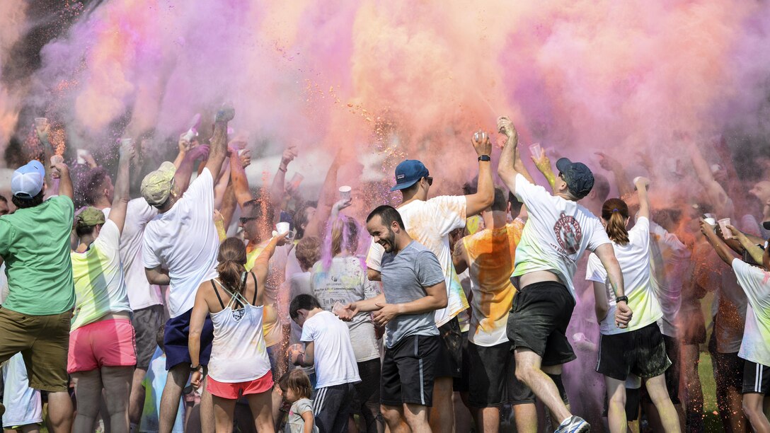 Participants throw colored powder in the air during a color run at Columbus Air Force Base in Lowndes County, Miss., July 8, 2017. More than 50 runners participated in the event, which was not timed. Air Force photo by Airman 1st Class Keith Holcomb