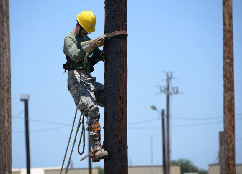 Airman Richard Cales, 366th Training Squadron electrical systems apprentice course student, climbs up a pole during training with the help of the Super Squeeze belt. This belt allows climbers to perform their duties without the danger of injury due to falling. Using a collection of straps and metal ridges, it allows climbers to grip the pole and eliminates the danger of slipping. (U.S. Air Force photo by Senior Airman Robert L. McIlrath)
