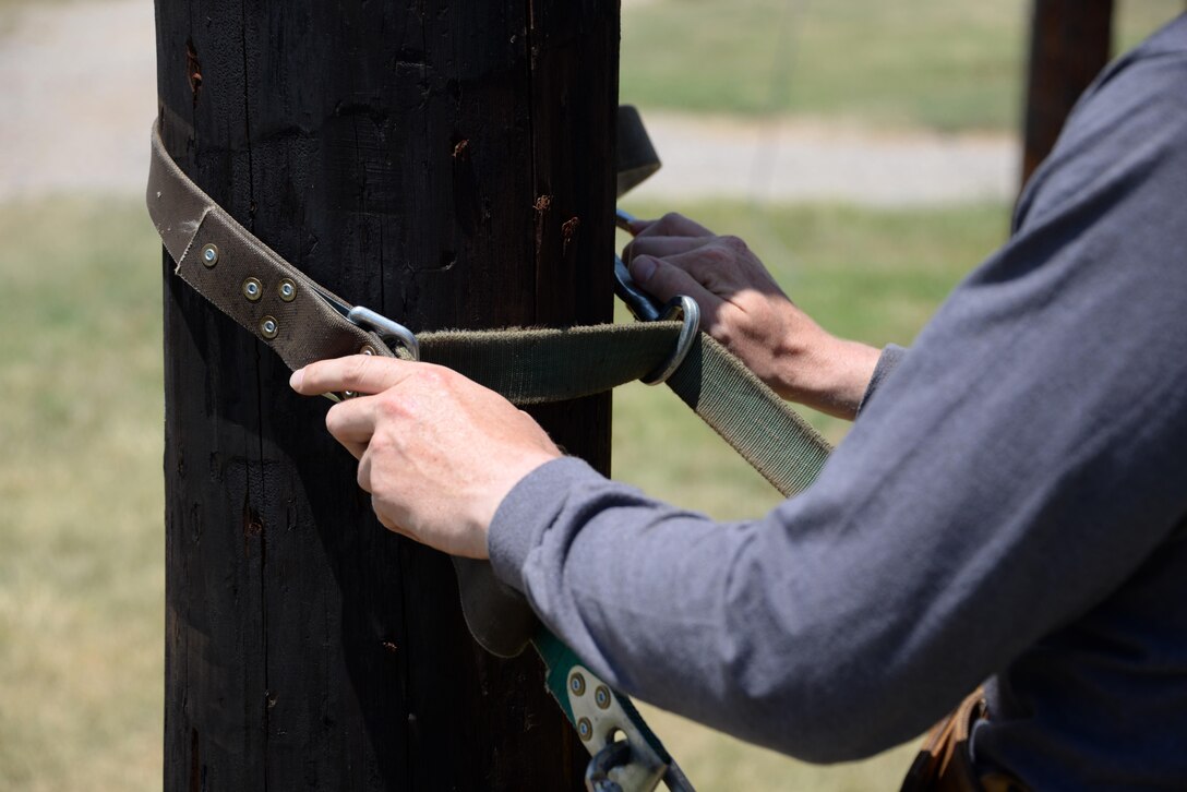 The innovative climbing belt, the Super Squeeze, uses a collection of straps and metal ridges to grip the pole and prevent climbers from falling should they slip while working. Since the implementation of the belt, the 366th Training Squadron has gone nearly four years without a single fall. (U.S. Air Force photo by Senior Airman Robert L. McIlrath)