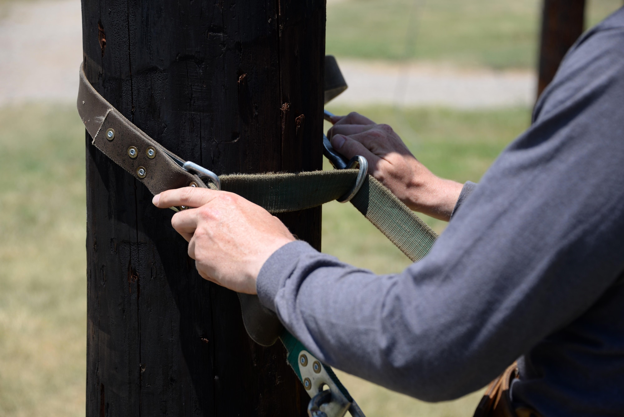 The innovative climbing belt, the Super Squeeze, uses a collection of straps and metal ridges to grip the pole and prevent climbers from falling should they slip while working. Since the implementation of the belt, the 366th Training Squadron has gone nearly four years without a single fall. (U.S. Air Force photo by Senior Airman Robert L. McIlrath)