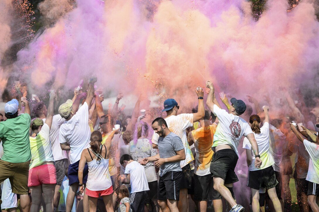 Participants throw colored powder in the air during a color run at Columbus Air Force Base in Lowndes County, Miss., July 8, 2017. More than 50 runners participated in the event, which was not timed. Air Force photo by Airman 1st Class Keith Holcomb