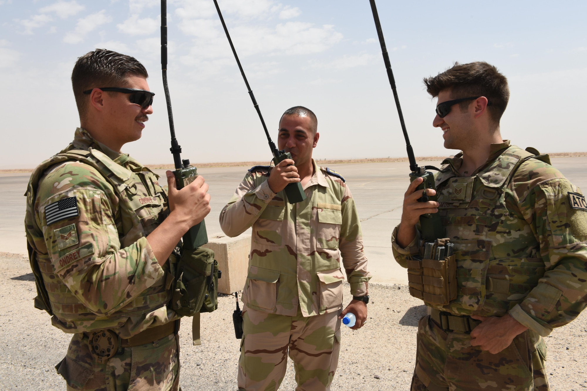 U.S. Air Force Senior Airman Troy Ondrey (left) and Staff Sgt. Matthew Ramos (right), both air traffic controllers deployed in support of Combined Joint Task Force – Operation Inherent Resolve and assigned to the 370th Air Expeditionary Advisory Group, Detachment 1, work with an Iraqi air force air traffic controller to coordinate the arrival of an incoming aircraft at Qayyarah West Airfield, Iraq, July 1, 2017. To ensure seamless control of both Iraqi and coalition air traffic, the U.S. Air Force’s 370th AEAG supports the CJTF-OIR advise and assist mission by having a small team of air advisors at Qayyarah West airfield working alongside the Iraqis advising and assisting in day-to-day airfield operations. CJTF-OIR is the global Coalition to defeat ISIS in Iraq and Syria. (U.S. Air Force photo by Tech. Sgt. Jonathan Hehnly)