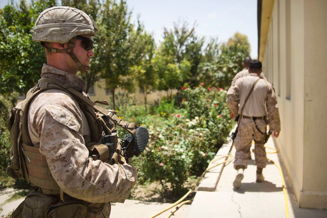 A U.S. Marine provides security for Marine advisors visiting the Helmand Provincial Police Headquarters in Lashkar Gah, Afghanistan, July 9, 2017. The Marines are assigned to Task Force Southwest, 2nd Marine Expeditionary Force, and are training, advising and assisting the Afghan National Army 215th Corps and the 505th Zone National Police. Marine Corps photo by Sgt. Justin T. Updegraff