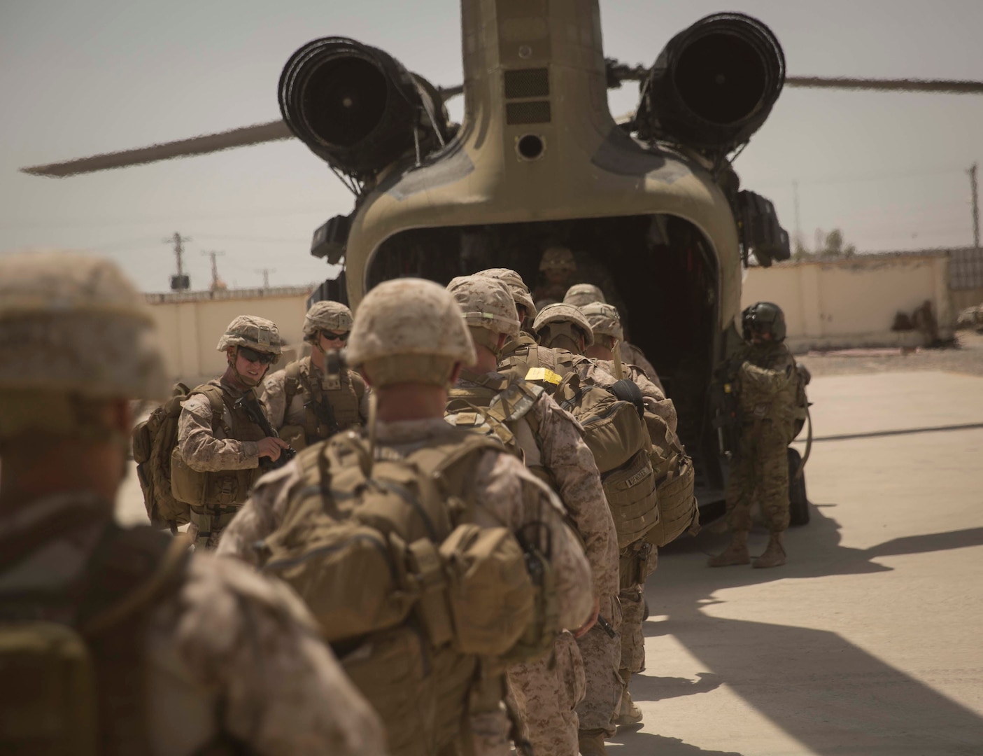 U.S. Marine advisors with Task Force Southwest embark on a CH-47 Chinook after a train, advise and assist mission at the Helmand Provincial Police Headquarters in Lashkar Gah, Afghanistan, July 9, 2017. This mission provided an opportunity for advisors to meet with their counterparts, review the security posture at the PHQ and ensure that Afghan National Defense and Security Forces have an effective defense of Lashkar Gah. (U.S. Marine Corps photo by Sgt. Justin T. Updegraff)