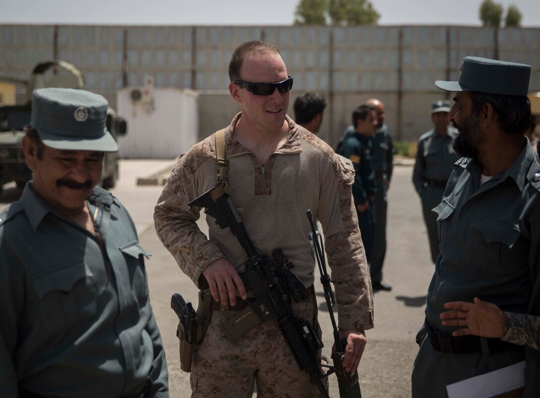 A U.S. Marine advisor with Task Force Southwest speaks with his counterparts during a train, advise and assist mission at the Helmand Provincial Police Headquarters in Lashkar Gah, Afghanistan, July 9, 2017. This mission provided an opportunity for advisors to meet with their counterparts, review the security posture at the PHQ and ensure that Afghan National Defense and Security Forces have an effective defense of Lashkar Gah. (U.S. Marine Corps photo by Sgt. Justin T. Updegraff)