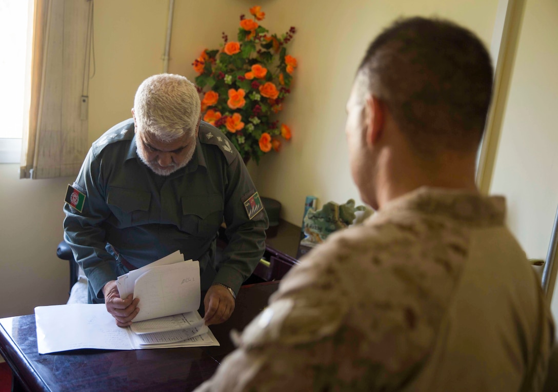 U.S. Marine advisors with Task Force Southwest speak with their counterpart during a train, advise and assist mission at the Helmand Provincial Police Headquarters in Lashkar Gah, Afghanistan, July 9, 2017. This mission provided an opportunity for advisors to meet with their counterparts, review the security posture at the PHQ and ensure that Afghan National Defense and Security Forces have an effective defense of Lashkar Gah. (U.S. Marine Corps photo by Sgt. Justin T. Updegraff)