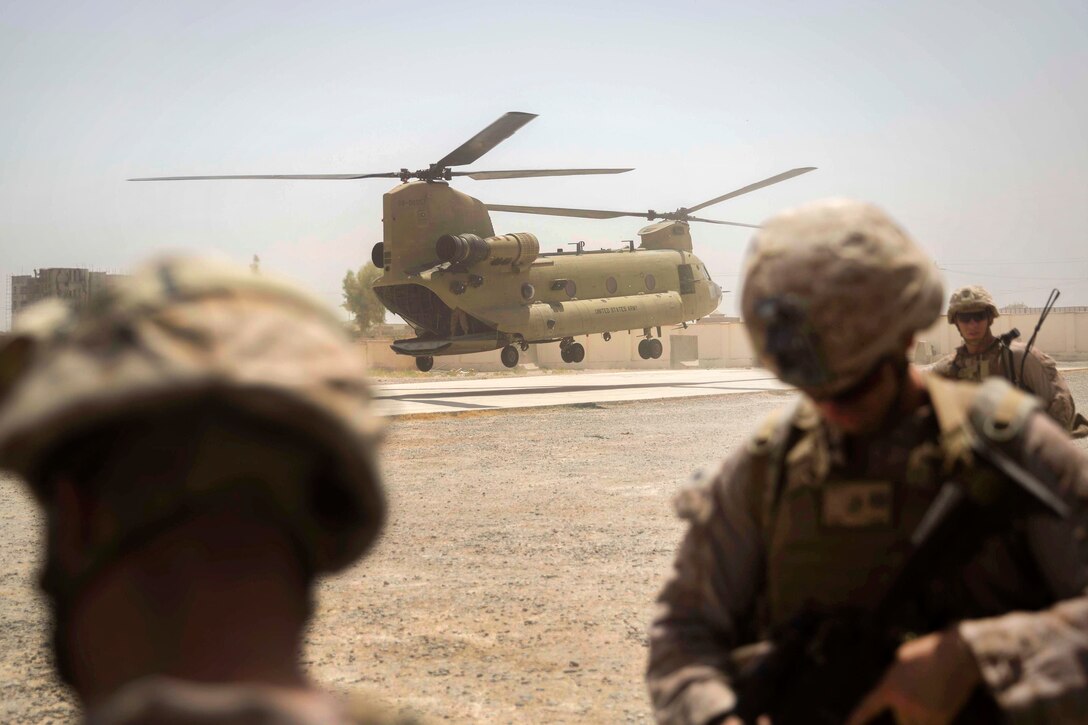 A CH-47 Chinook helicopter prepares to land and transport U.S. Marine advisors after a train, advise and assist mission at the Helmand Provincial Police Headquarters in Lashkar Gah, Afghanistan, July 9, 2017. Marine Corps photo by Sgt. Justin T. Updegraff