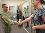 DLA Senior Enlisted Leader Command Sgt. Maj. Charles Tobin greets customer support managers in the Planning and Support Division of DLA Aviation at Ogden during a trip to Hill Air Force Base, Utah. 