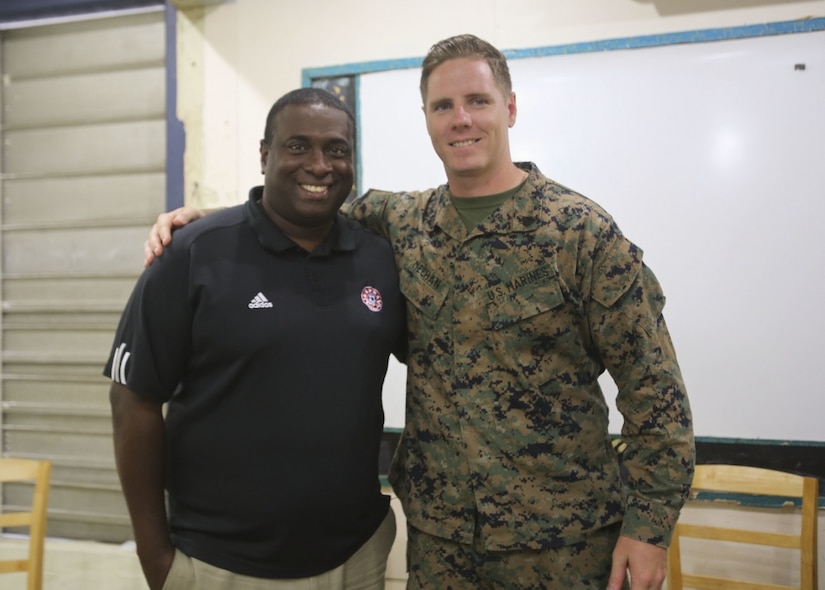 Marine Corps Sgt. Mike Meehan poses with Anthony Creece, his former soccer coach, at Mucurapo West Secondary School in Port-of-Spain, Trinidad and Tobago, June 16, 2017. Meehan, a civil affairs specialist with 4th Civil Affairs Group, visited Creece, a teacher in and native of Trinidad and Tobago, while participating in Phase II of Exercise Tradewinds 2017 in Chaguaramas. Meehan and other Marines visited the school days before to donate sports equipment as part of a community relations event. Tradewinds is a U.S. Southern Command-sponsored annual exercise involving 20 nations focusing on increasing the interoperability of the participating nations to promote the security of the Caribbean region. Marine Corps photo by Sgt. Olivia McDonald