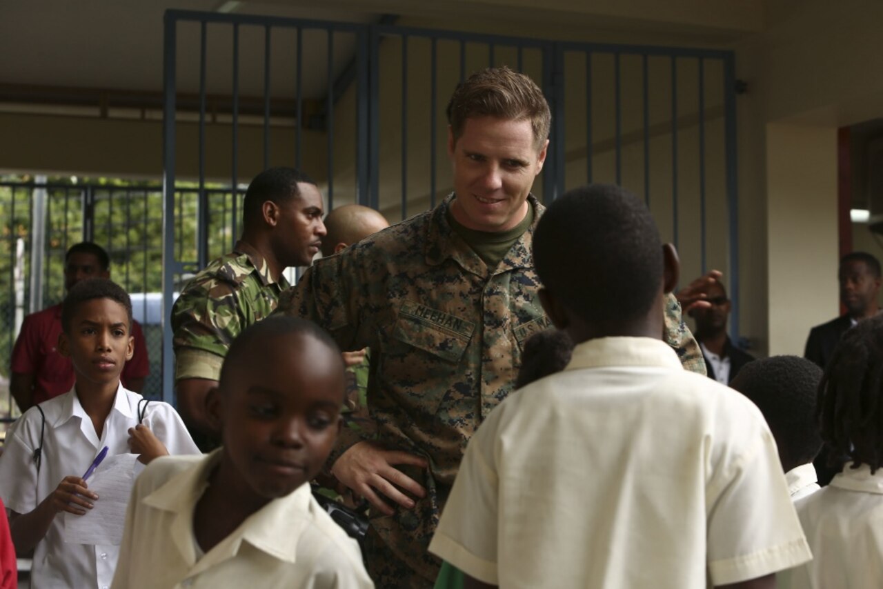 Marine Corps Sgt. Mike Meehan, a civil affairs specialist with 4th Civil Affairs Group, talks to young students at the Carenage Boy Government Primary School at a community relations event during Phase II of Exercise Tradewinds 2017 in Chaguaramas, Trinidad and Tobago, June 16, 2017. Tradewinds is a U.S. Southern Command-sponsored annual exercise involving 20 nations focusing on increasing the interoperability of the participating nations to promote the security of the Caribbean region. U.S. Marines are providing training and logistical support for Phase II of Tradewinds. Marine Corps photo by Sgt. Olivia McDonald