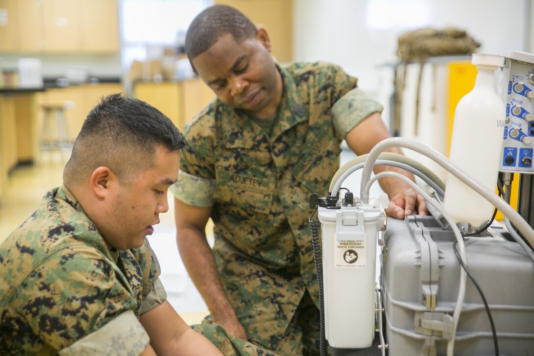 Petty Officer 2nd Class John Lagmay (left) and Petty Officer 3rd Class Gabriel Adjetey (right), dental corpsmen with 4th Dental Battalion, 4th Marine Logistics Group, Marine Forces Reserve, set up dental equipment in preparation for Innovative Readiness Training Louisiana Care 2017 at East St. John High School in Reserve, La., July 11, 2017. The Louisiana Care Innovative Readiness Training event is a joint-service medical mission that provides the military with “hands-on” readiness training opportunities, while at the same time providing direct and lasting benefits to the residents of Louisiana. (Photo by U.S. Marine Pvt. Samantha Schwoch/Released.)