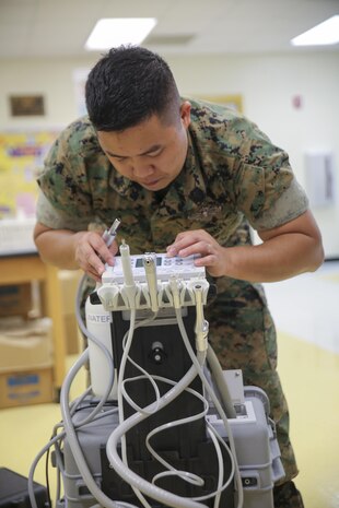 Petty Officer 2nd Class John Lagmay, a dental corpsman with 4th Dental Battalion, 4th Marine Logistics Group, Marine Forces Reserve, sets up dental equipment in preparation for Innovative Readiness Training Louisiana Care 2017 at East St. John High School in Reserve, La., July 11, 2017. The Louisiana Care Innovative Readiness Training event is a joint-service medical mission that provides the military with “hands-on” readiness training opportunities, while at the same time providing direct and lasting benefits to the residents of Louisiana. (Photo by U.S. Marine Pvt. Samantha Schwoch/Released.)