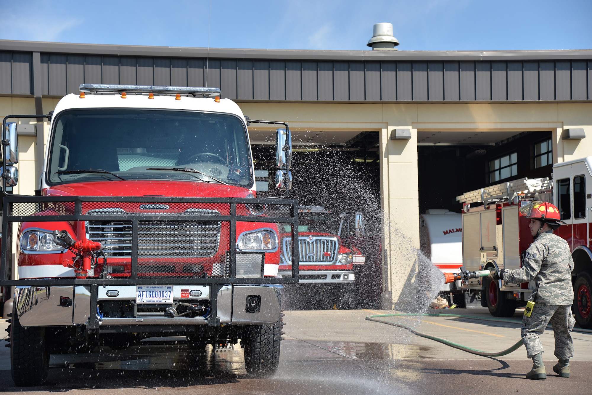 Staff Sgt. Patrick Gander, 341st Civil Engineer Squadron firefighter, hoses down the fire department’s new brush truck July 6, 2017, at Malmstrom Air Force Base, Mont. After nearly three years of waiting and preparation, the firefighters at the 341st Civil Engineer Squadron fire department have finally added a new fire truck to their inventory of engines. (U.S. Air Force photo/Airman 1st Class Daniel Brosam)