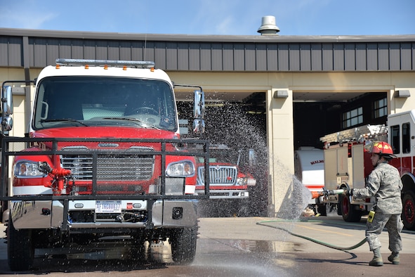 Staff Sgt. Patrick Gander, 341st Civil Engineer Squadron firefighter, hoses down the fire department’s new brush truck July 6, 2017, at Malmstrom Air Force Base, Mont. After nearly three years of waiting and preparation, the firefighters at the 341st Civil Engineer Squadron fire department have finally added a new fire truck to their inventory of engines. (U.S. Air Force photo/Airman 1st Class Daniel Brosam)