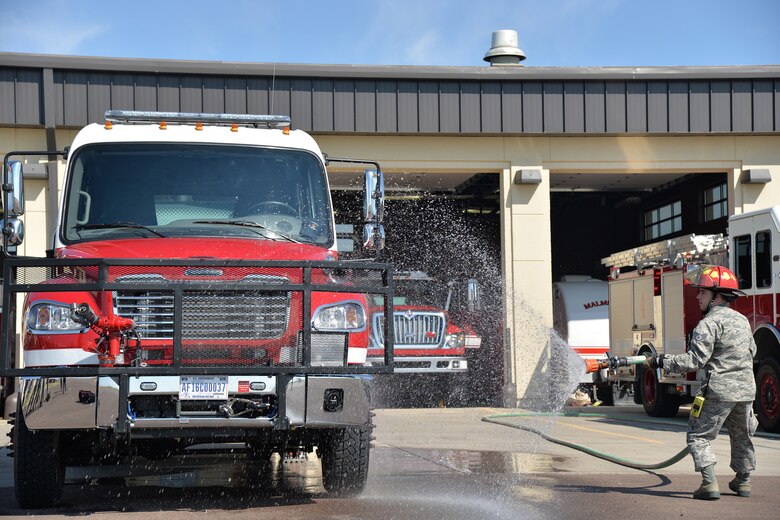 Staff Sgt. Patrick Gander, 341st Civil Engineer Squadron firefighter, hoses down the fire department’s new brush truck July 6, 2017, at Malmstrom Air Force Base, Mont. After nearly three years of waiting and preparation, the firefighters at the 341st Civil Engineer Squadron fire department have finally added a new fire truck to their inventory of engines. (U.S. Air Force photo/Airman 1st Class Daniel Brosam)