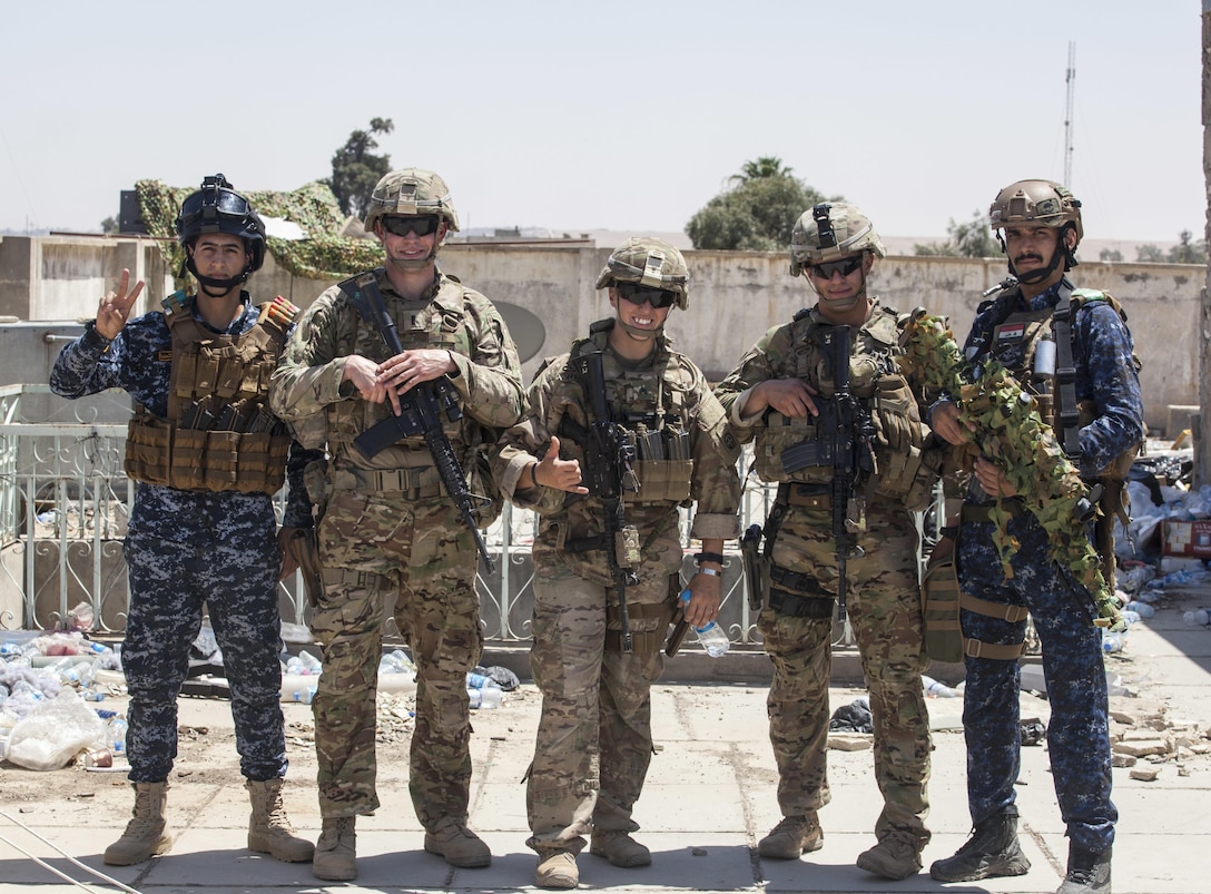 U.S. Army Paratroopers, deployed in support of Combined Joint Task Force – Operation Inherent Resolve and assigned to 1st Squadron, 73rd Cavalry Regiment, 2nd Brigade Combat Team, 82nd Airborne Division, pose for a photo with Iraqi Federal Police in Mosul, Iraq, June 29, 2017. The 2nd BCT, 82nd Abn. Div., enables Iraqi security force partners through the advise and assist mission, contributing planning, intelligence collection and analysis, force protection and precision fires to achieve the military defeat of ISIS. CJTF-OIR is the global Coalition to defeat ISIS in Iraq and Syria. (U.S. Army photo by Cpl. Rachel Diehm.)